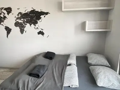 a bedroom with a bed with a world map on the wall at TOM ROOM - Cracow City Centre in Kraków