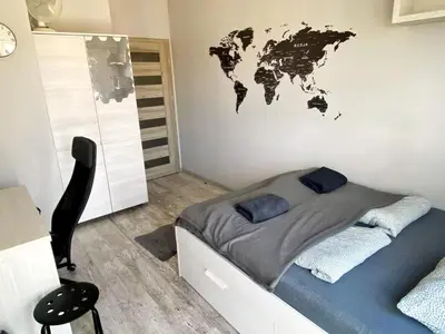 a bedroom with a bed with a map on the wall at TOM ROOM - Cracow City Centre in Kraków