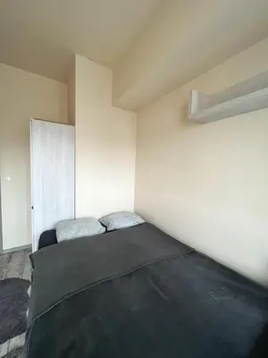 a bedroom with a bed with a black blanket at TOM ROOM - Cracow City Centre in Kraków