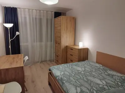 a bedroom with a bed and a dresser at U Cioci in Kraków