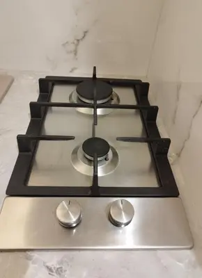 a stove top with three burners on a counter at U Cioci in Kraków