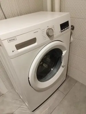 a white washing machine sitting in a bathroom at U Cioci in Kraków