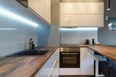 a kitchen with a sink and a counter at Cozy apartment with garden prestigious location in Kraków