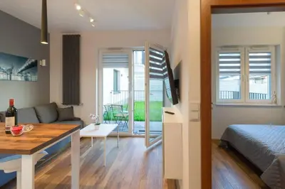 a small living room with a bed and a couch at Cozy apartment with garden prestigious location in Kraków