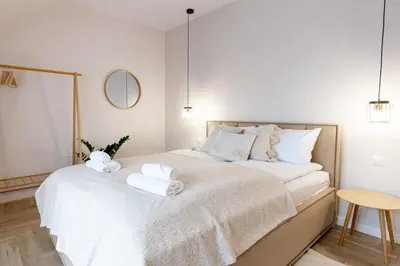 a bedroom with a bed with towels on it at ULUBIONE MIEJSCE ZATOR in Zator