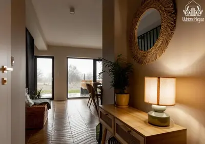 a living room with a mirror and a table with a lamp at ULUBIONE MIEJSCE ZATOR in Zator