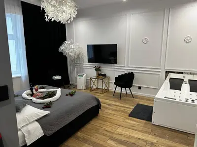 a living room with a bed and a television at Apartament z Jacuzzi Kraków SHINE Starowiślna in Kraków
