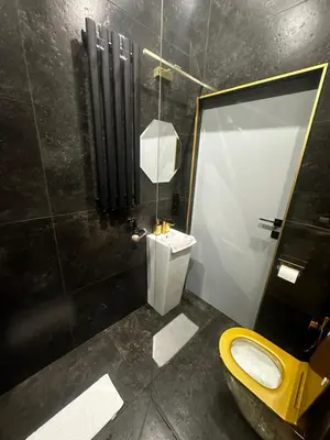 a bathroom with a yellow toilet and a shower at Apartament z Jacuzzi Kraków SHINE Starowiślna in Kraków