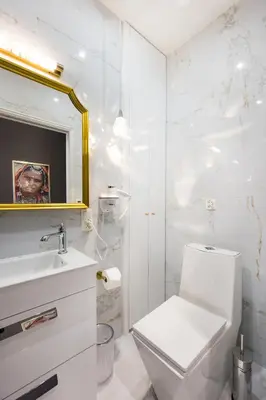 a bathroom with a toilet and a sink and a mirror at Salomea krakow apartments Bożego Ciała in Kraków