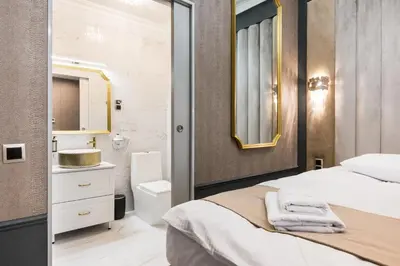 a bedroom with a bed and a sink and a mirror at Salomea krakow apartments Bożego Ciała in Kraków