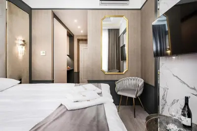 a hotel room with a bed and a chair at Salomea krakow apartments Bożego Ciała in Kraków
