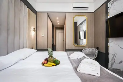 a hotel room with a bed with a bowl of fruit on it at Salomea krakow apartments Bożego Ciała in Kraków