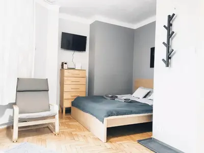 a bedroom with a bed and a chair at Daszyńskiego 7 by Homeprime in Kraków