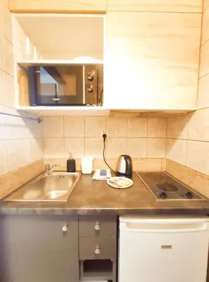a kitchen with a sink and a counter top at Daszyńskiego 7 by Homeprime in Kraków