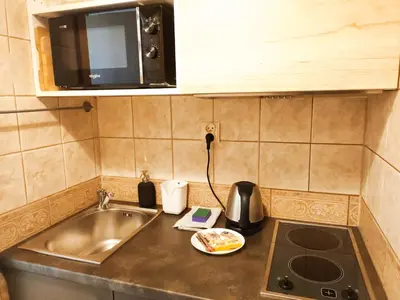 a kitchen counter with a sink and a microwave at Daszyńskiego 7 by Homeprime in Kraków