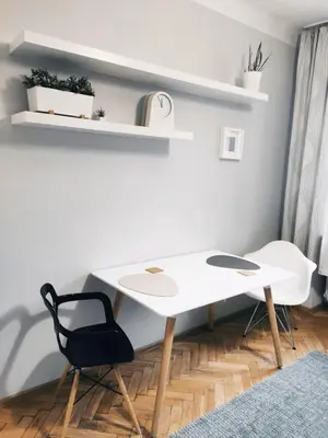 a white desk and a black chair in a room at Daszyńskiego 7 by Homeprime in Kraków