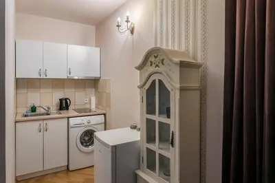 a small kitchen with a washing machine and a washer at The Spiski Palace Apartments in Kraków