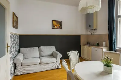 a living room with a couch and a table at The Spiski Palace Apartments in Kraków