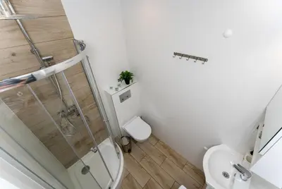 a bathroom with a shower and a toilet at Czarnowiejska Mini Studio with loggia in Kraków