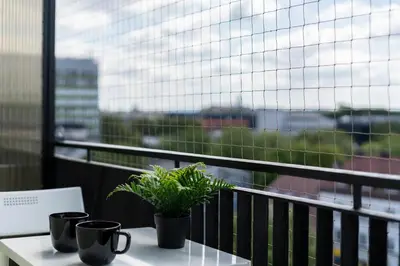 a table with two plants sitting on top of a balcony at Czarnowiejska Mini Studio with loggia in Kraków