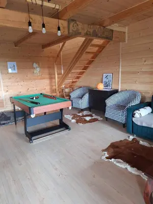 a room with a ping pong table in a attic at Urokliwy drewniany dom z widokiem na Tatry in Tokarnia