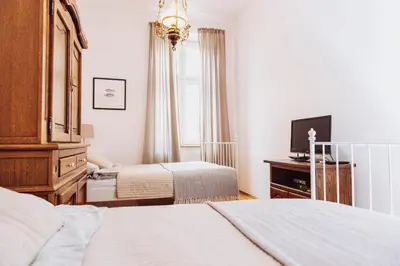 a hotel room with two beds and a television at Kraków Old Town - Kazimierz Dajwór in Kraków