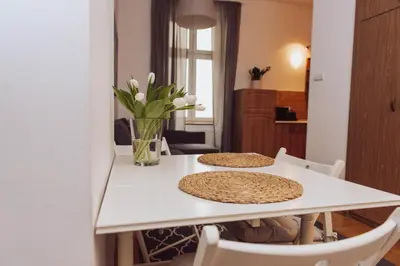 a white table with two pizzas on top of it at Kraków Old Town - Kazimierz Dajwór in Kraków