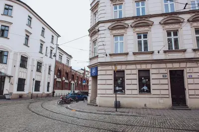 a cobblestone street in a city with buildings at Kraków Old Town - Kazimierz Dajwór in Kraków