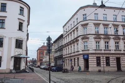 a city street with buildings and people walking on the street at Kraków Old Town - Kazimierz Dajwór in Kraków