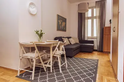 a living room with a table and a couch at Kraków Old Town - Kazimierz Dajwór in Kraków