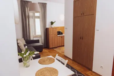 a living room with a white table and chairs at Kraków Old Town - Kazimierz Dajwór in Kraków