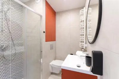 a bathroom with a shower and a toilet and a sink at Apartamenty Meiera in Kraków