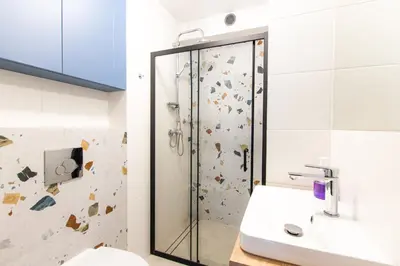 a bathroom with a shower and a sink at Apartamenty Meiera in Kraków