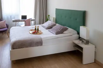 a bedroom with a bed with a plate of food on it at Happy House Apartamenty in Kraków