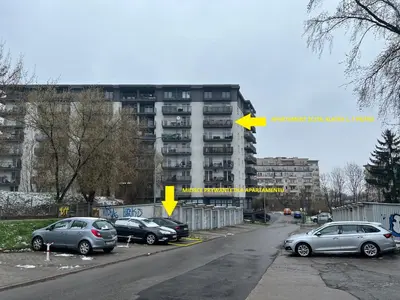 a street with cars parked in front of a building at Apartament Zlota Jesień 2C in Kraków