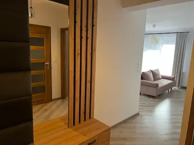 a living room with a sliding door and a couch at Apartament Zlota Jesień 2C in Kraków