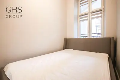 a white bed in a room with a window at Elegancki apartament w centrum miasta-Kazimierz in Kraków