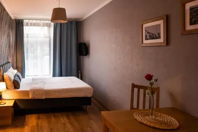 a bedroom with a bed and a table with a vase on it at Pokoje na Różanej Zator - 2 km od Energylandii in Zator