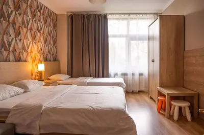 a hotel room with two beds and a window at Pokoje na Różanej Zator - 2 km od Energylandii in Zator