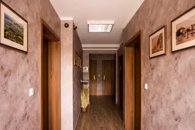 a hallway in a building with paintings on the walls at Pokoje na Różanej Zator - 2 km od Energylandii in Zator
