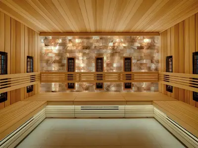 an empty courtroom with wooden walls and a stone wall at Stradom House, Autograph Collection in Kraków