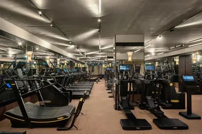 a gym with a bunch of treadms and machines at Stradom House, Autograph Collection in Kraków