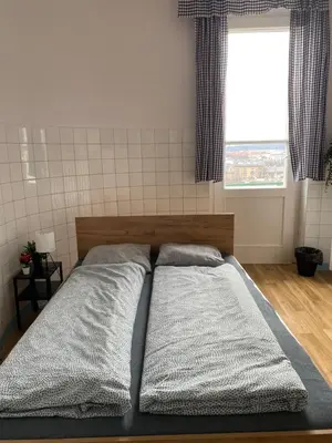 a bedroom with a bed with two pillows and a window at Vintage Rooms in Old Town in Kraków