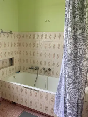 a bath tub in a bathroom with a shower curtain at Vintage Rooms in Old Town in Kraków