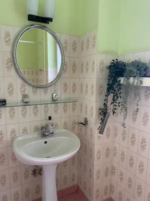 a bathroom with a sink and a mirror at Vintage Rooms in Old Town in Kraków