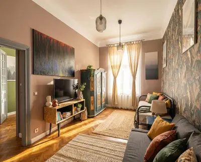 a living room with a couch and a tv at Opera Apartments in Kraków