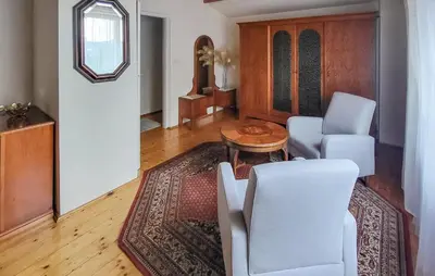 a living room with white chairs and a table at 6 Bedroom Amazing Home In Mucharz in Mucharz
