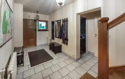 a bathroom with a tile floor and a hallway at 6 Bedroom Amazing Home In Mucharz in Mucharz