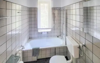 a bathroom with a tub and a toilet and a sink at 6 Bedroom Amazing Home In Mucharz in Mucharz