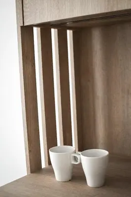 two white cups sitting on a table next to a window at Pensjonat Zdrojowy Apartamenty in Rabka